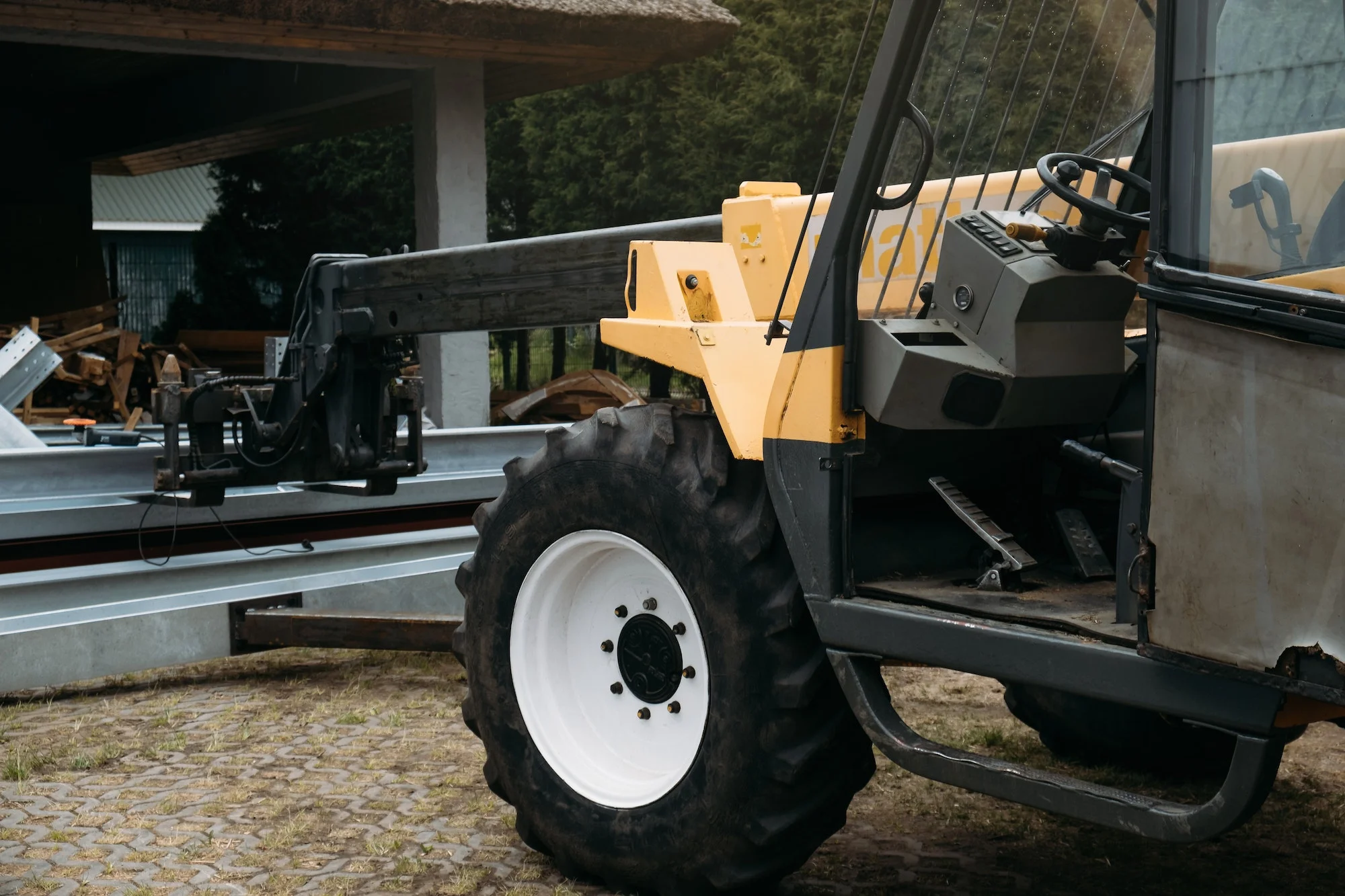 Forklift on a construction site, preparing to raise construction parts